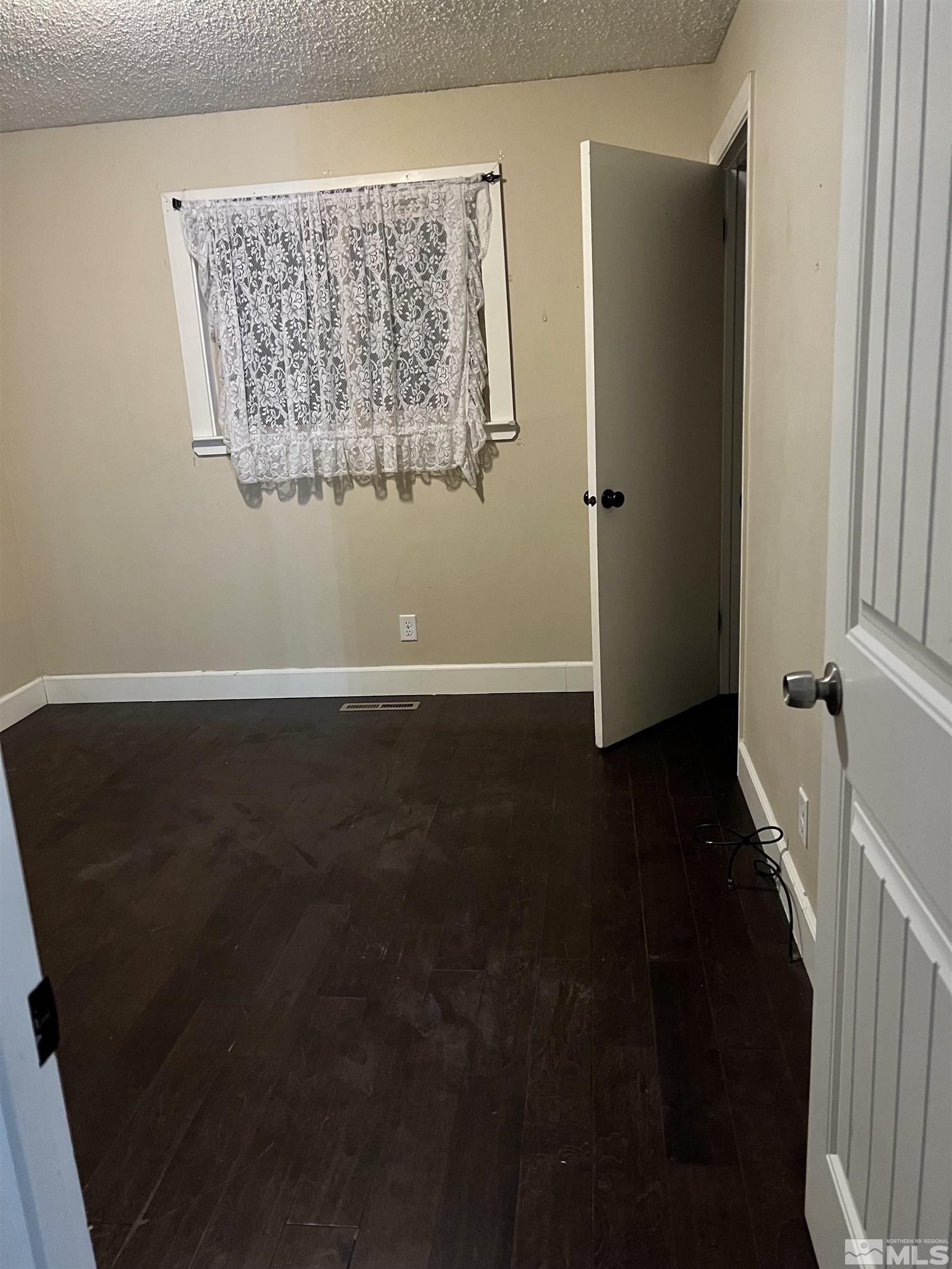 908 Lester Avenue Reno, NV 89502 - Photo 20 of 35 a view of a livingroom with wooden floor and a cabinet