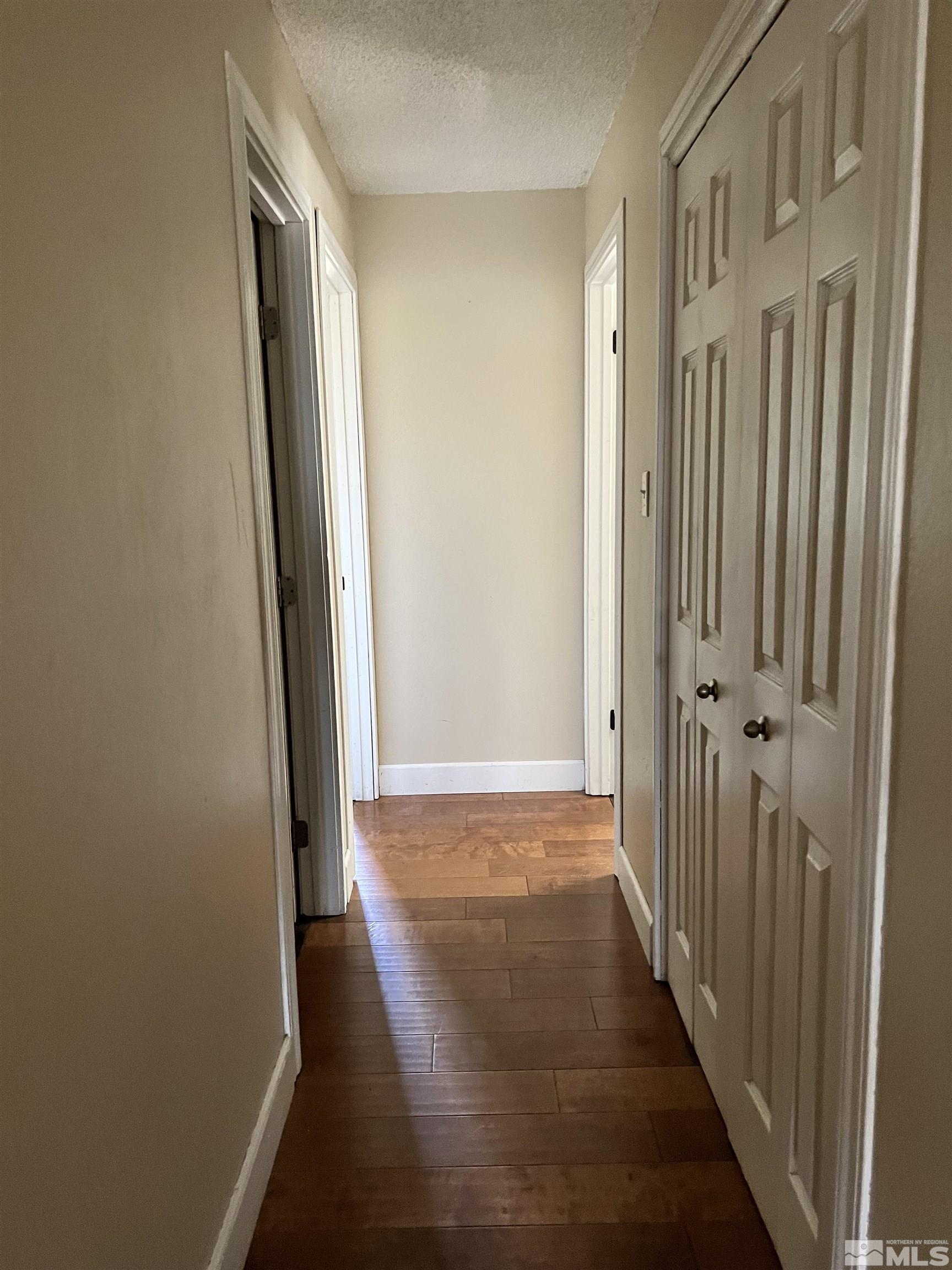 908 Lester Avenue Reno, NV 89502 - Photo 23 of 35 a view of a hallway with wooden floor and staircase