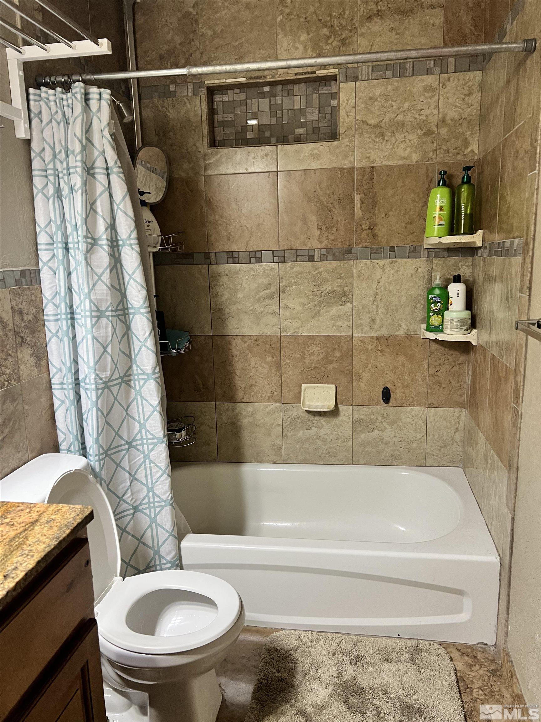 908 Lester Avenue Reno, NV 89502 - Photo 25 of 35 a bathroom with a toilet and shower