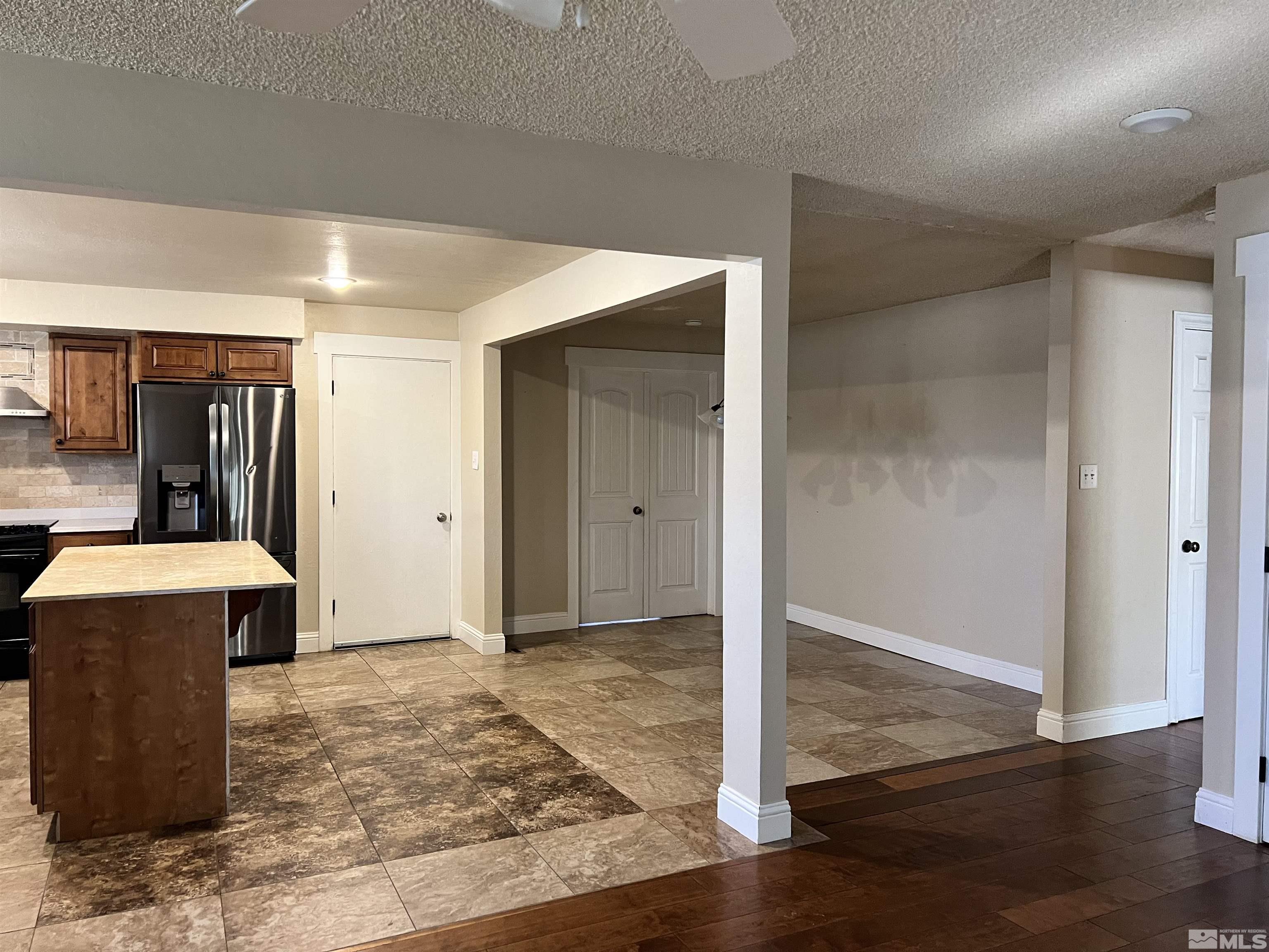 908 Lester Avenue Reno, NV 89502 - Photo 5 of 35 a view of a hallway with wooden floor and staircase