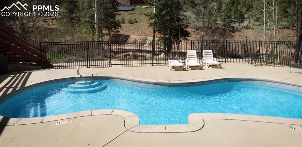 339 Eagle Mountain Road Manitou Springs, CO 80829 - Photo 19 of 19 a view of a swimming pool with a patio