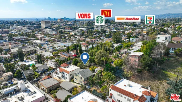 an aerial view of a houses with yard