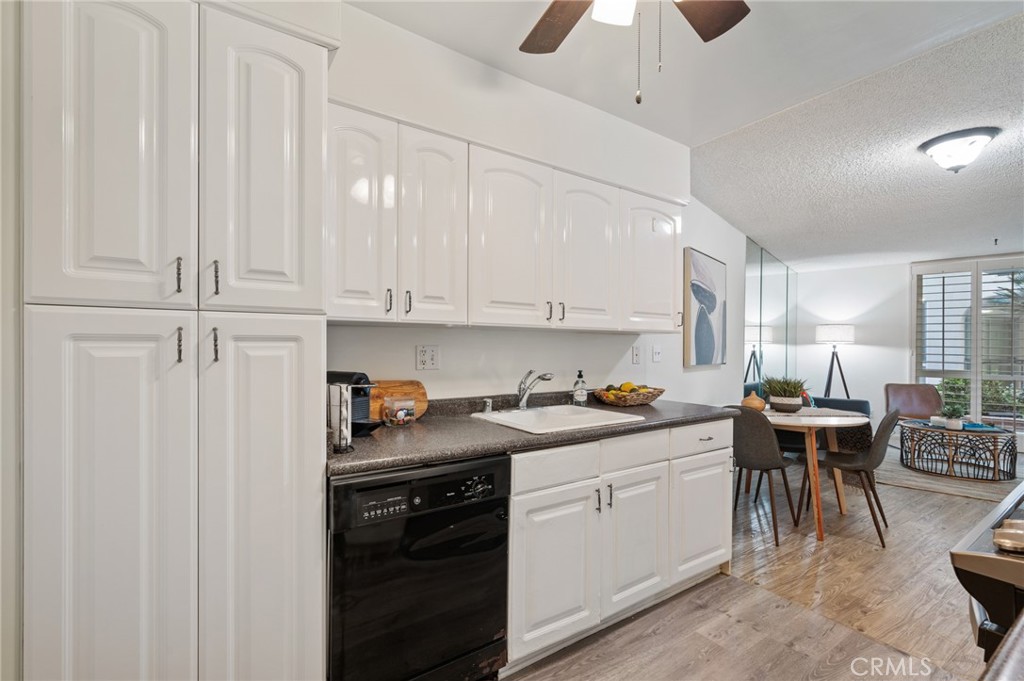 565 Esplanade, Unit 104 Redondo Beach, CA 90277 - Photo 18 of 42 a kitchen with stainless steel appliances granite countertop a sink a stove a dining table and chairs