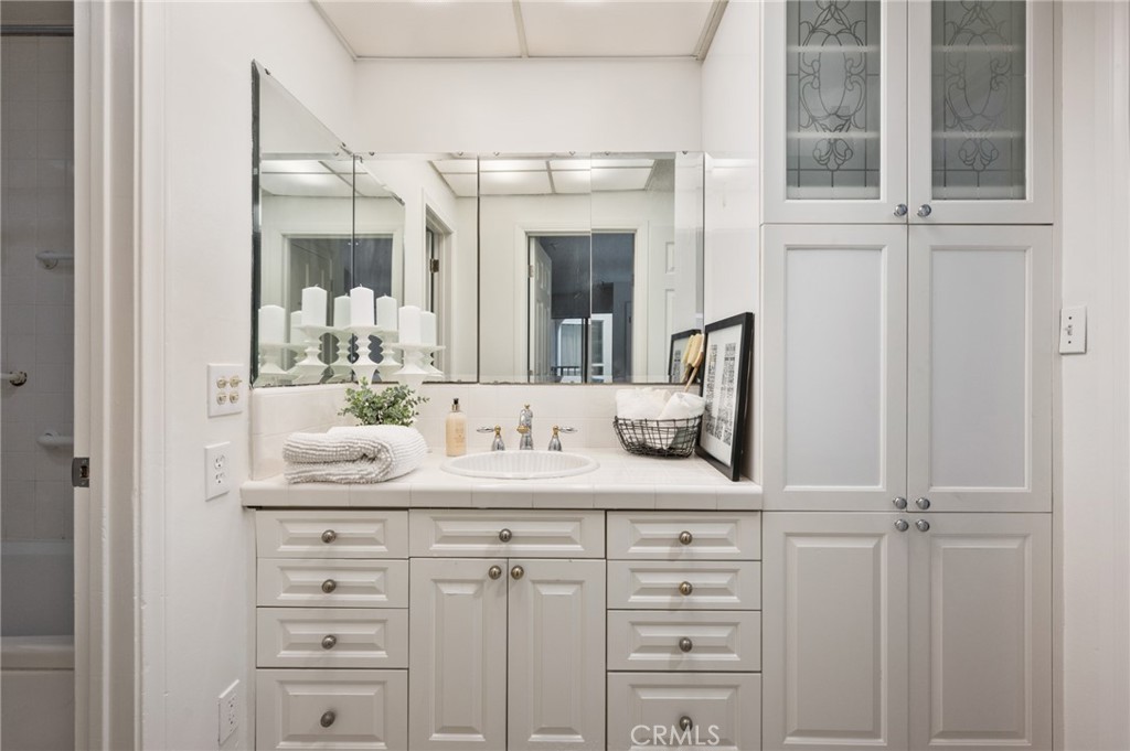 565 Esplanade, Unit 104 Redondo Beach, CA 90277 - Photo 29 of 42 a bathroom with a double vanity sink and mirror