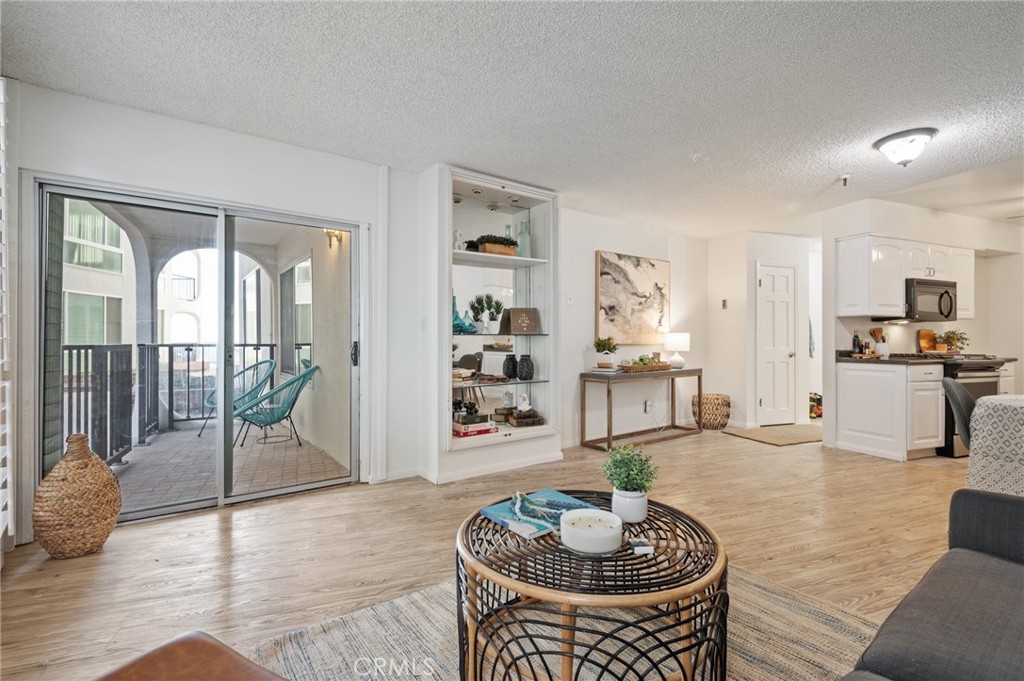 565 Esplanade, Unit 104 Redondo Beach, CA 90277 - Photo 6 of 42 a living room with furniture and a wooden floor