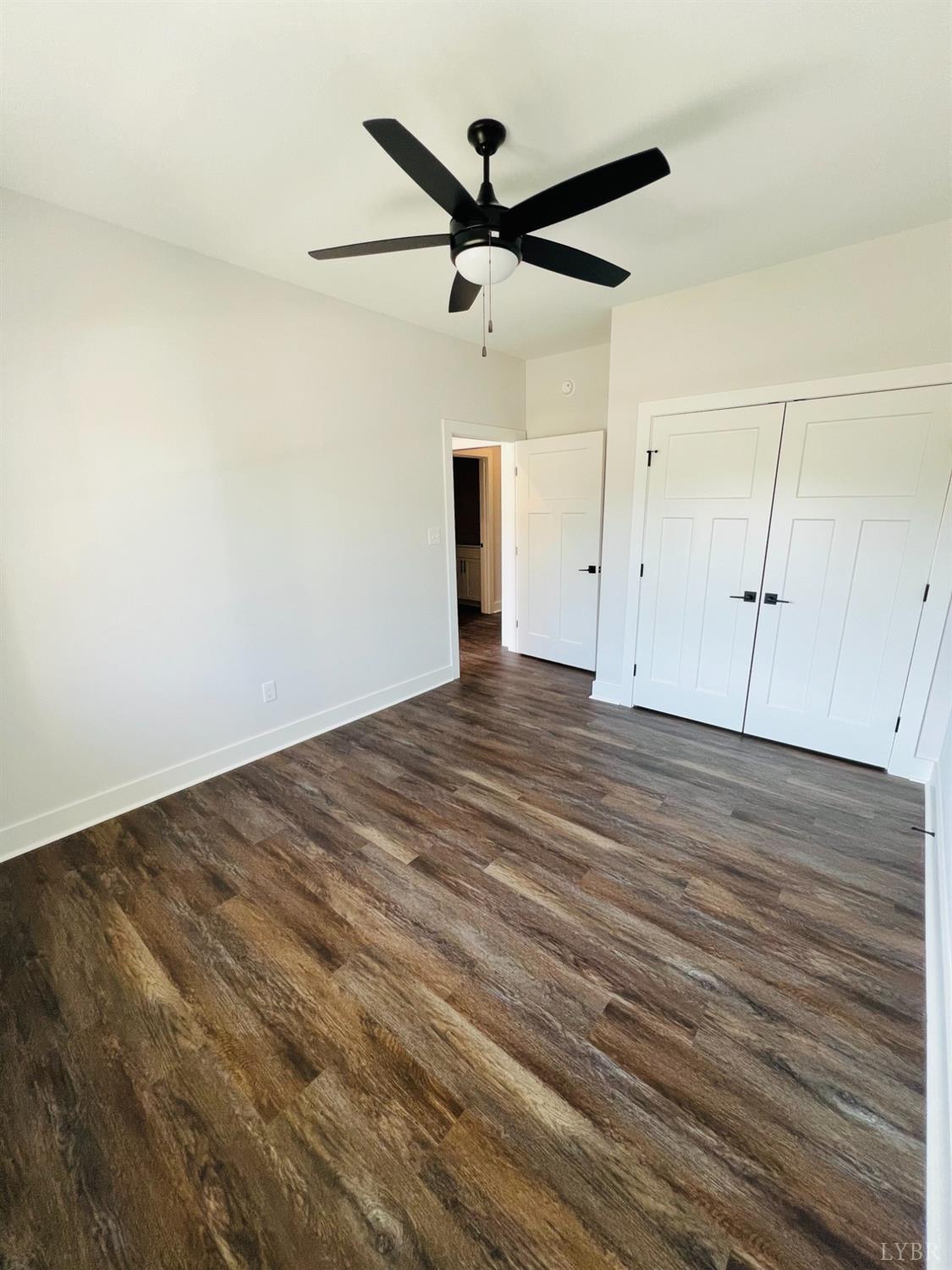 74 Lockridge Lane Lynchburg, VA 24502 - Photo 14 of 19 an empty room with wooden floor and a ceiling fan