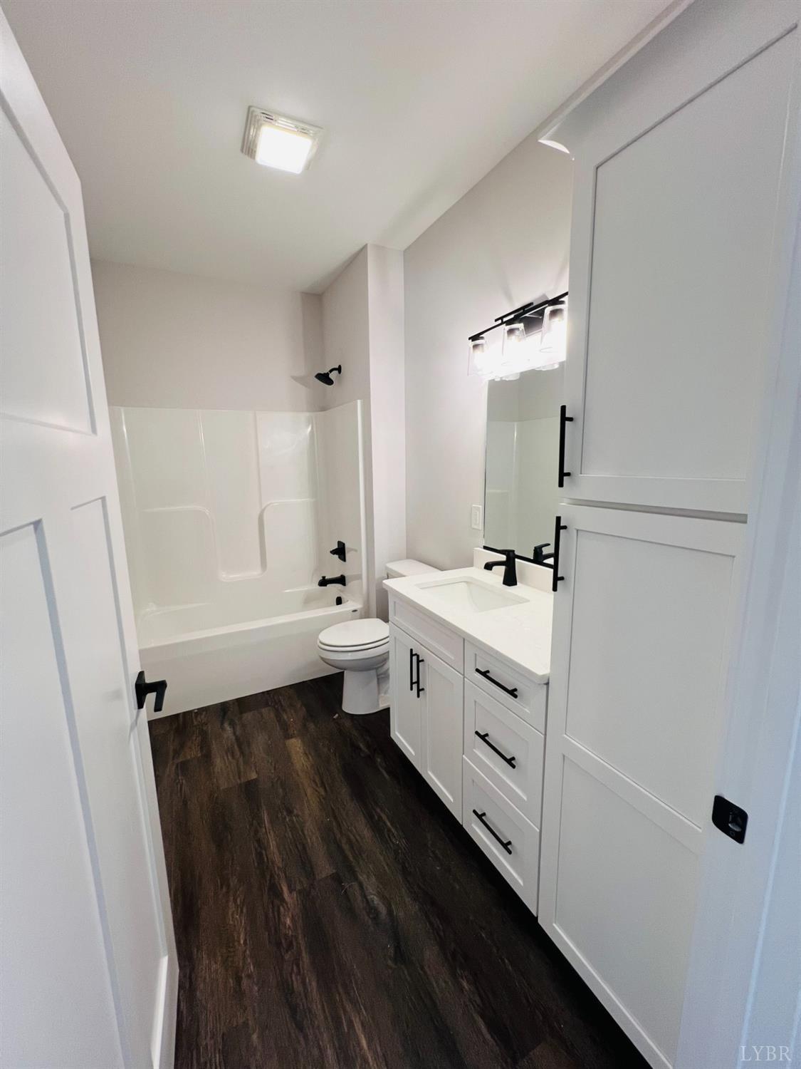 74 Lockridge Lane Lynchburg, VA 24502 - Photo 17 of 19 a bathroom with a double vanity sink a toilet and a mirror