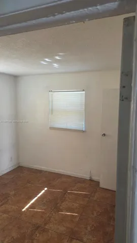 a view of a room with wooden floor and cabinet