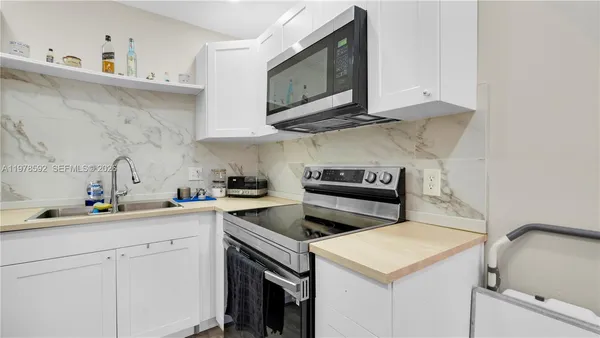 a kitchen with a sink and cabinets