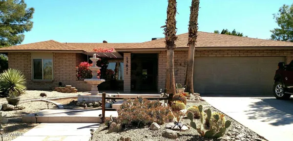 a view of a house with backyard sitting area and garden