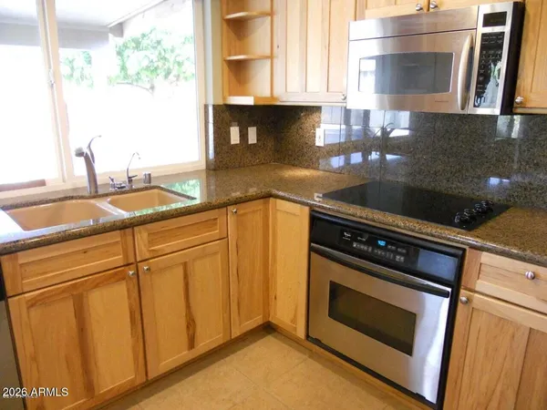 a dining room with furniture a chandelier and window