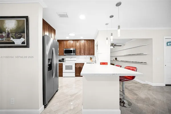 a view of kitchen with cabinets and stainless steel appliances