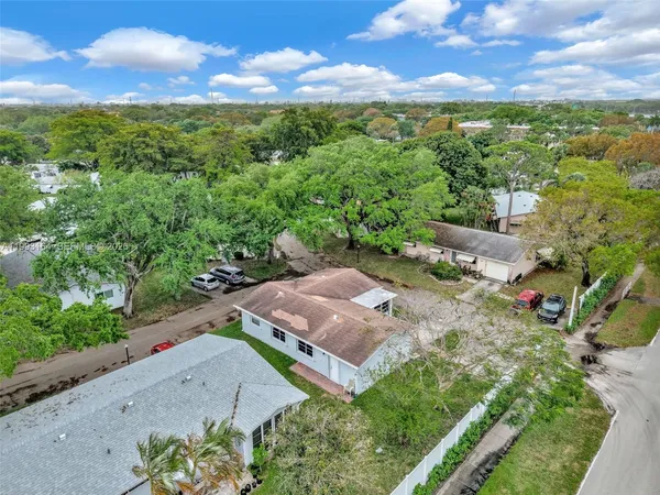 a view of a backyard with large trees