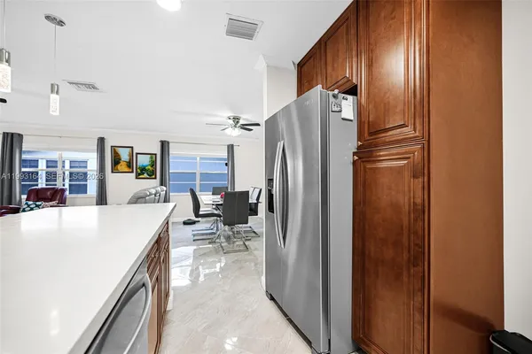 a kitchen with stainless steel appliances a refrigerator and a stove