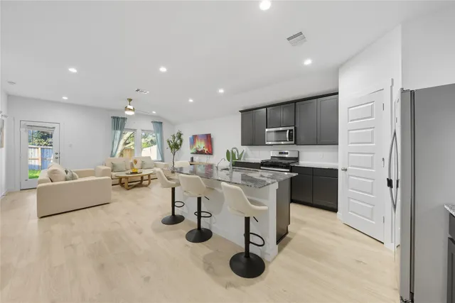 a kitchen with granite countertop a table and chairs