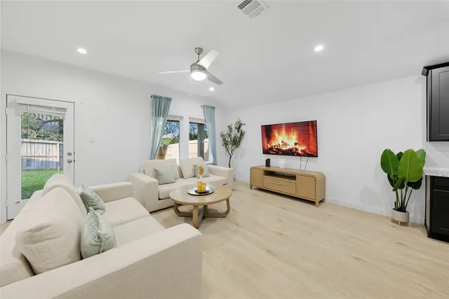 a living room with furniture and a flat screen tv