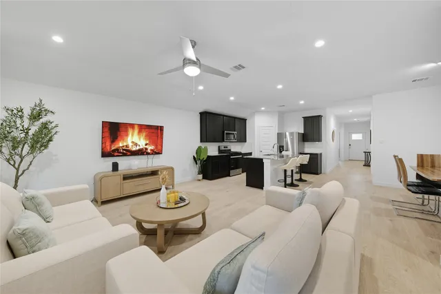 a spacious bedroom with a bed and a chandelier