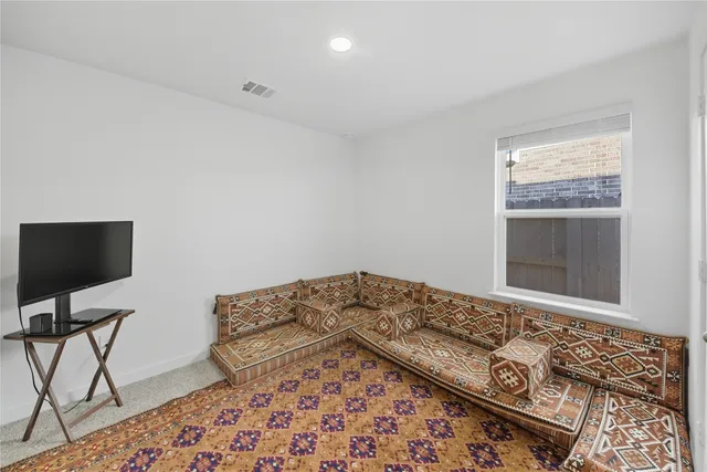 a view of a livingroom with wooden floor and workspace