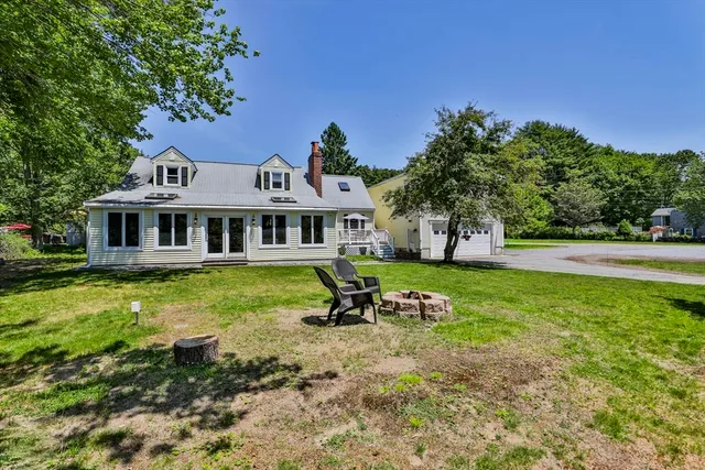 a front view of a house with a yard table and chairs