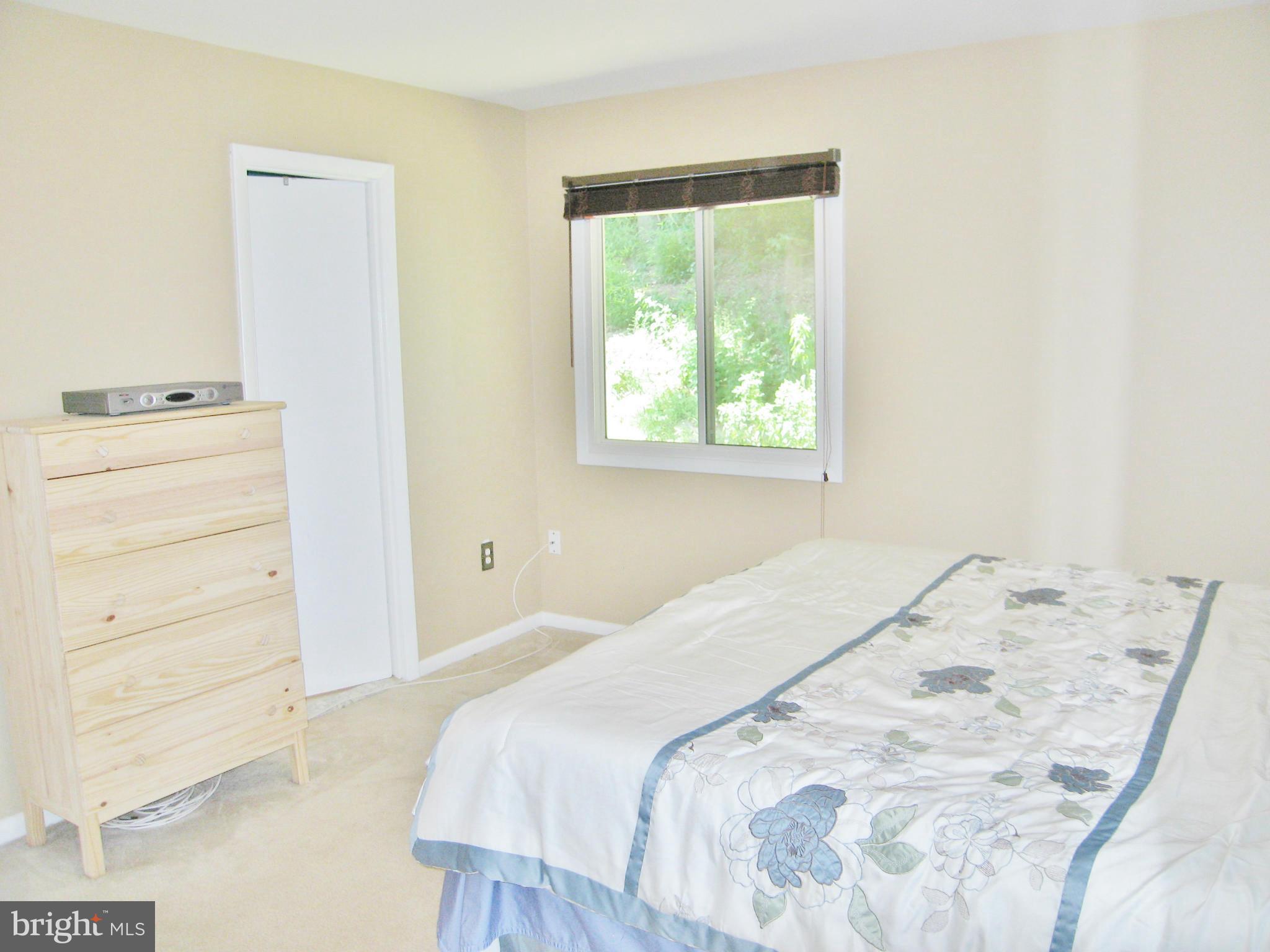 8000 Orange Plank Road Springfield, VA 22153 - Photo 14 of 30 a bedroom with a bed and a window