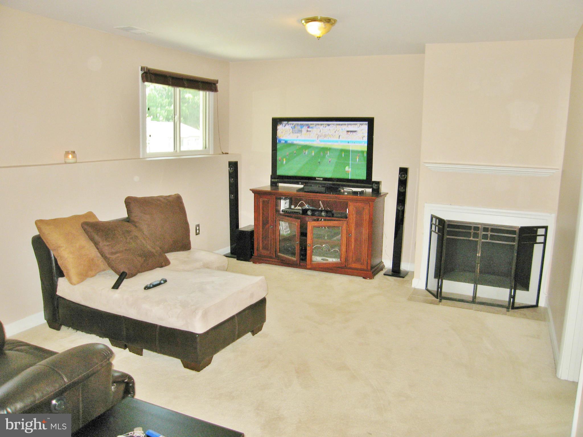 8000 Orange Plank Road Springfield, VA 22153 - Photo 22 of 30 a living room with furniture and a flat screen tv
