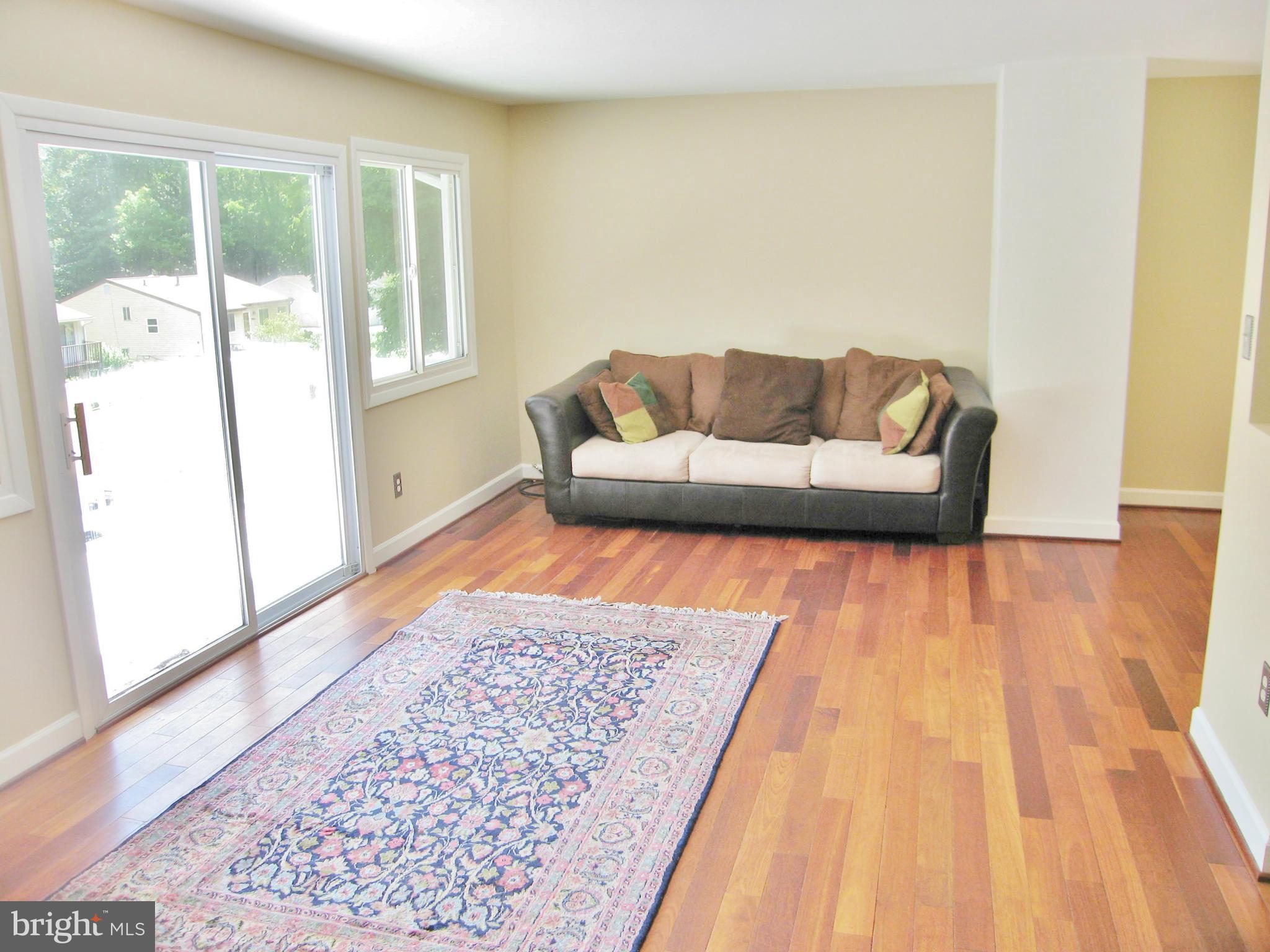 8000 Orange Plank Road Springfield, VA 22153 - Photo 4 of 30 a living room with a couch and wooden floor