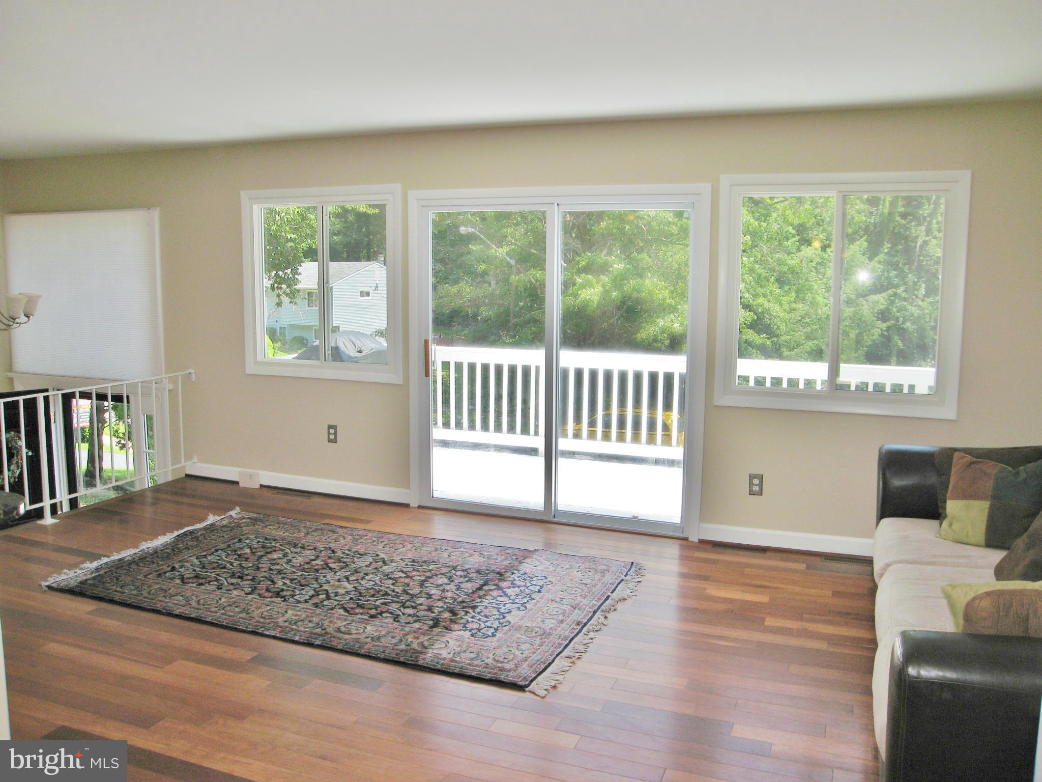 8000 Orange Plank Road Springfield, VA 22153 - Photo 5 of 30 a view of an empty room with wooden floor and a window