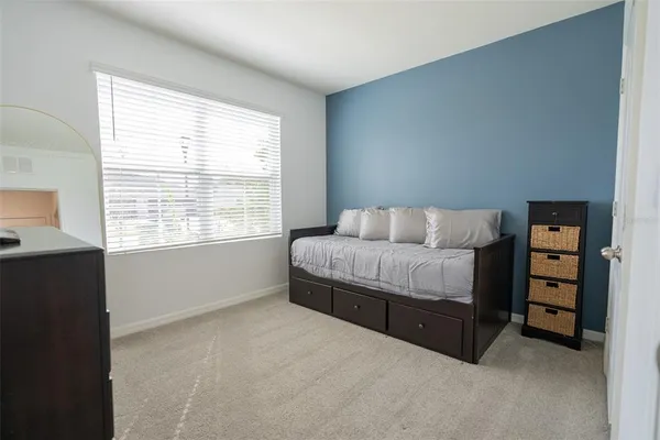 a bathroom with a granite countertop sink toilet and mirror