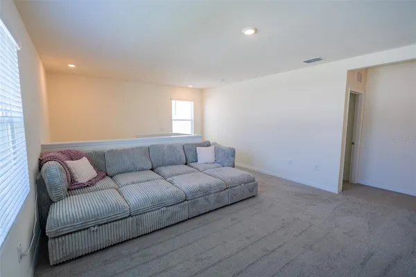 a bed sitting in a bedroom next to a window