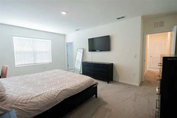 a bedroom with a bed and window