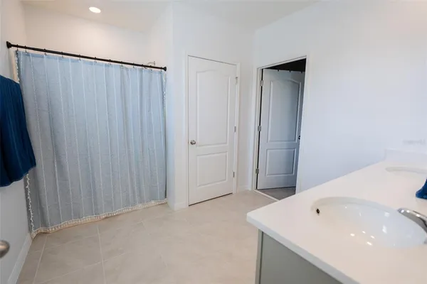 a view of a hallway with a livingroom and a bathroom