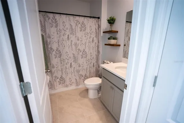 a view of a house with backyard and a garden