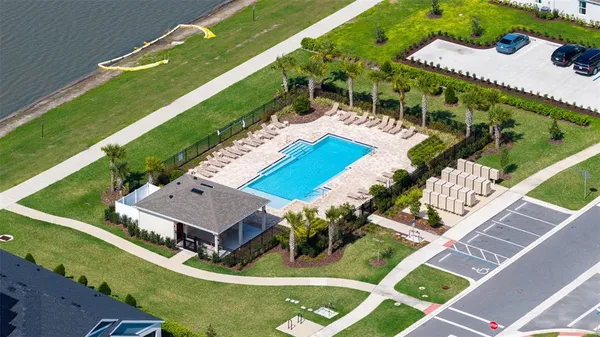an aerial view of residential house with pool and yard
