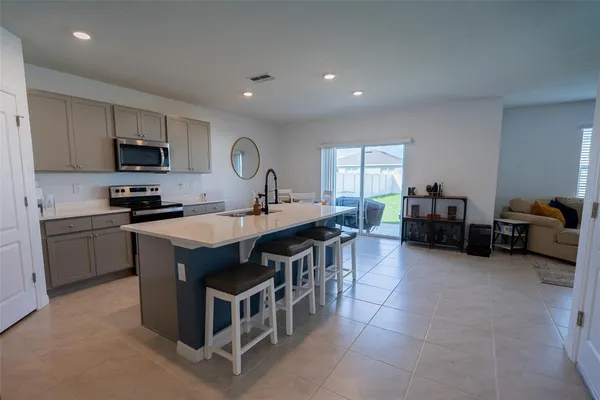 a kitchen with kitchen island a sink and appliances