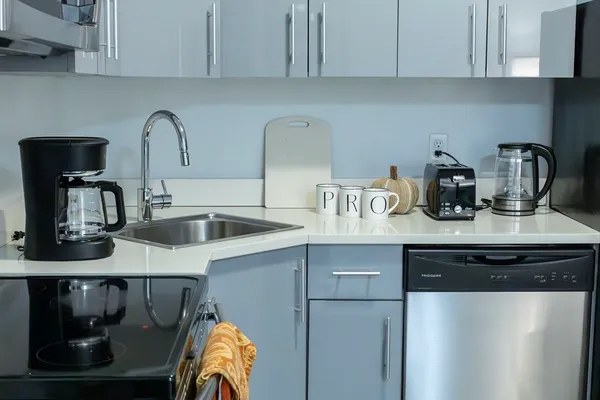 a kitchen with stainless steel appliances granite countertop a sink and cabinets