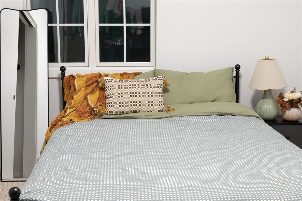 1505 Commonwealth Avenue, Unit 501 Boston, MA 02135 - Photo 7 of 10 a bed sitting in a bedroom next to a window