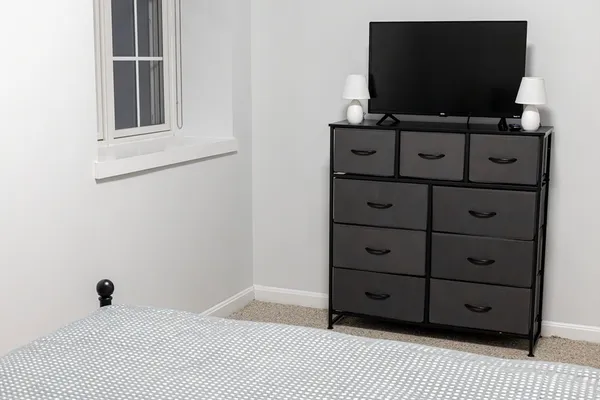 a room with wooden floor and flat screen tv