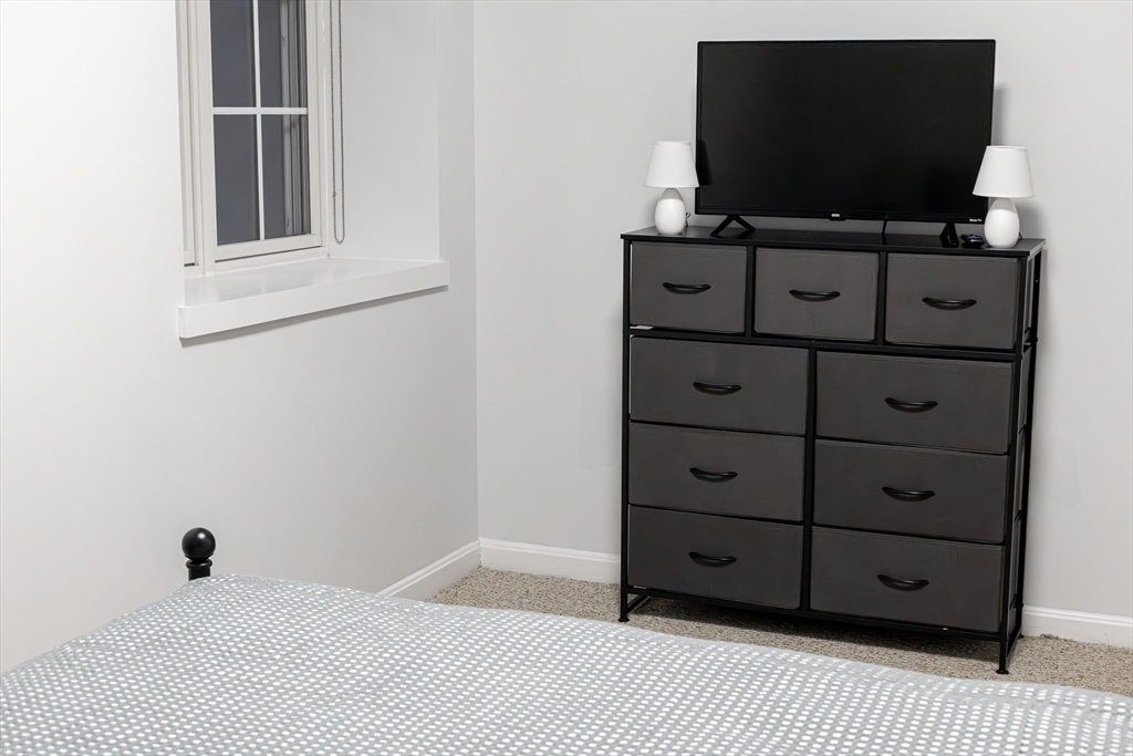 1505 Commonwealth Avenue, Unit 501 Boston, MA 02135 - Photo 8 of 10 a room with wooden floor and flat screen tv