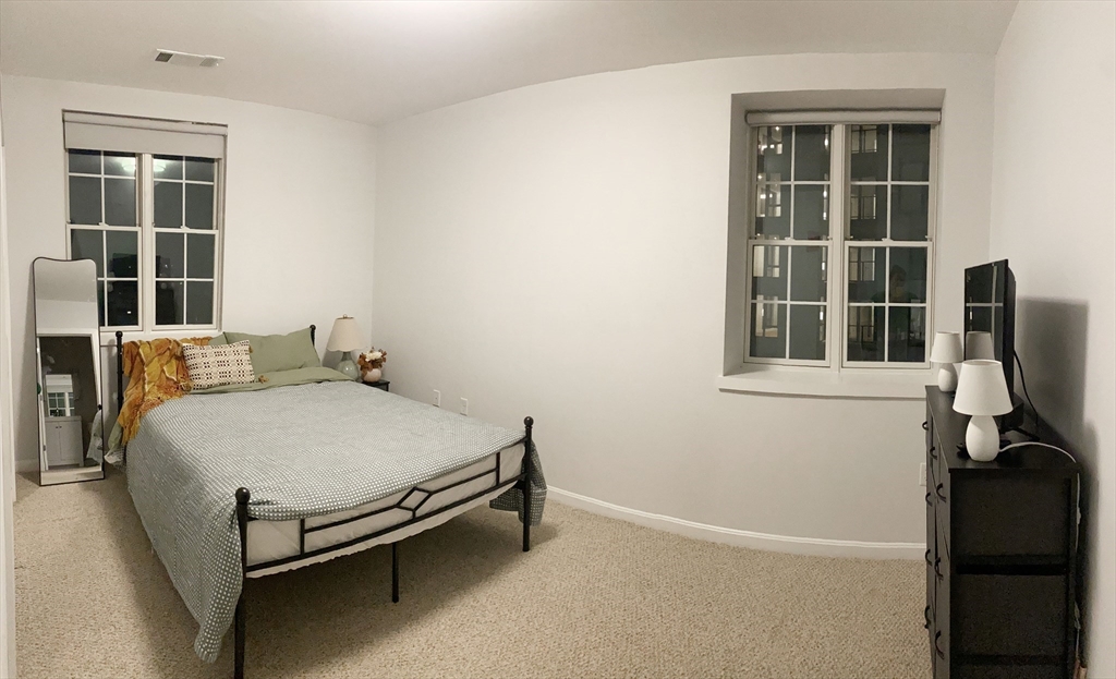 1505 Commonwealth Avenue, Unit 501 Boston, MA 02135 - Photo 9 of 10 a bed room with a bed and a window