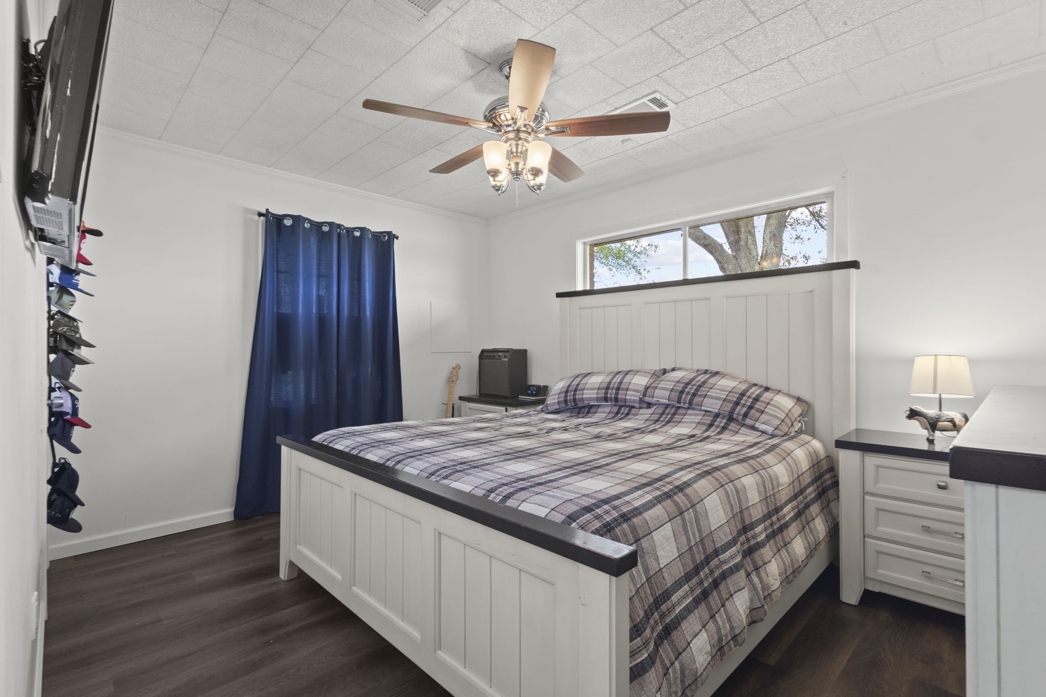 19961 Englin Road Winnie, TX 77665 - Photo 20 of 26 a bedroom with a bed and a chandelier