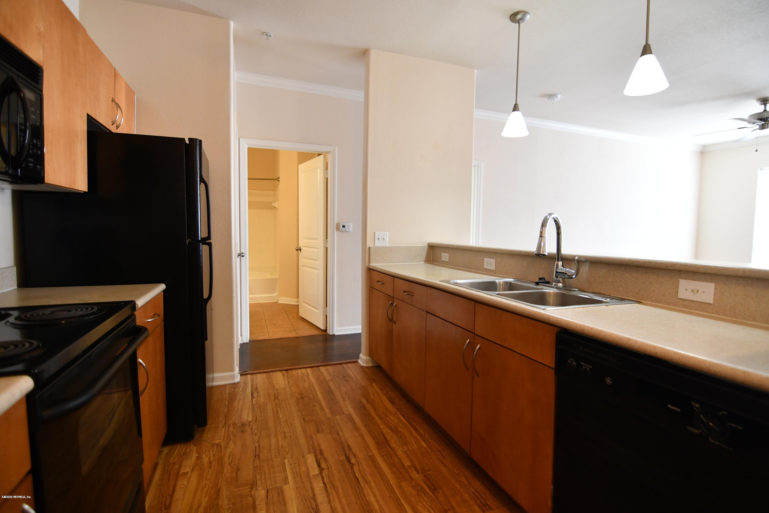 8290 Gate Parkway West, Unit 206 Jacksonville, FL 32216 - Photo 13 of 19 a kitchen with a sink a counter top space stainless steel appliances and cabinets