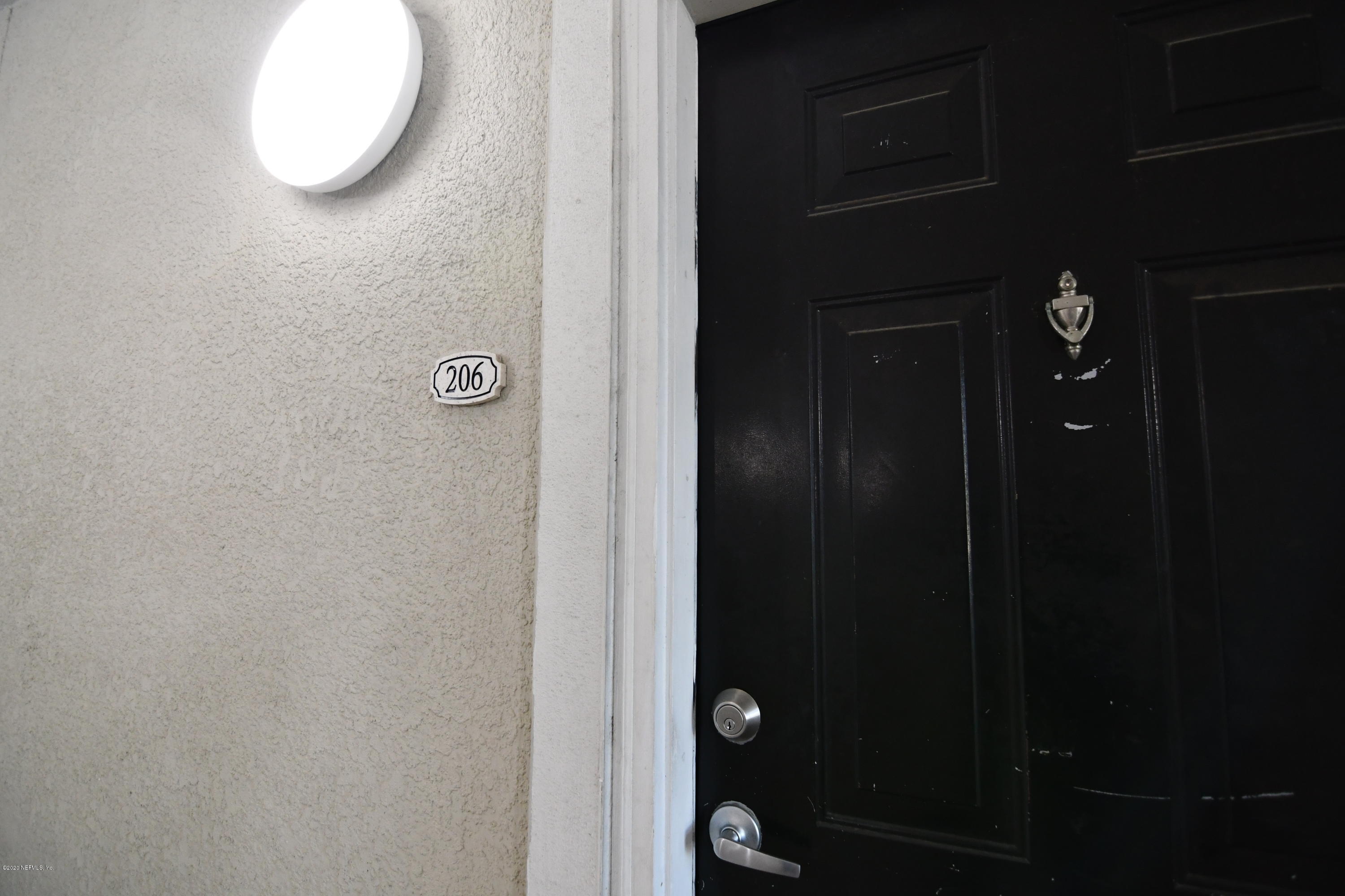 8290 Gate Parkway West, Unit 206 Jacksonville, FL 32216 - Photo 14 of 19 a bathroom with a mirror and a shower