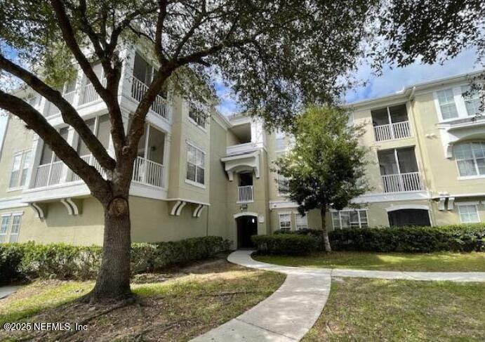 8290 Gate Parkway West, Unit 206 Jacksonville, FL 32216 - Photo 15 of 19 a front view of a house with garden