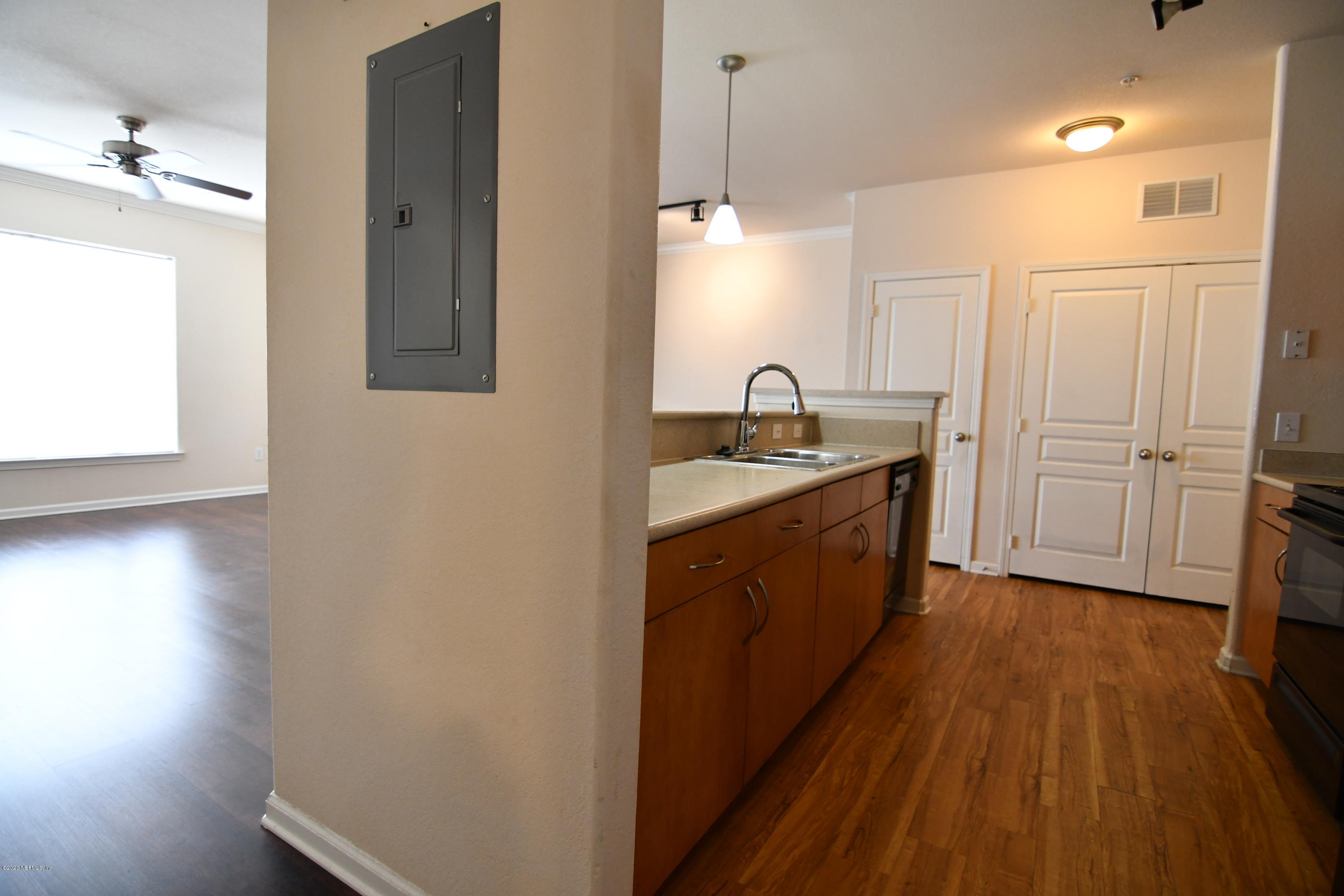 8290 Gate Parkway West, Unit 206 Jacksonville, FL 32216 - Photo 3 of 19 a kitchen with a sink and wooden floor