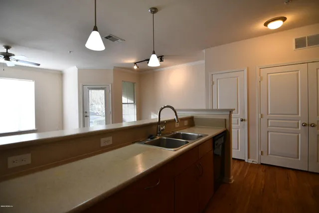 a kitchen with a sink and chandelier