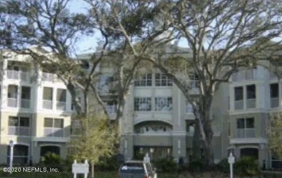a front view of a building with glass windows and brick walls