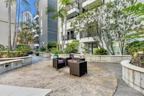 a view of a patio with table and chairs and potted plants