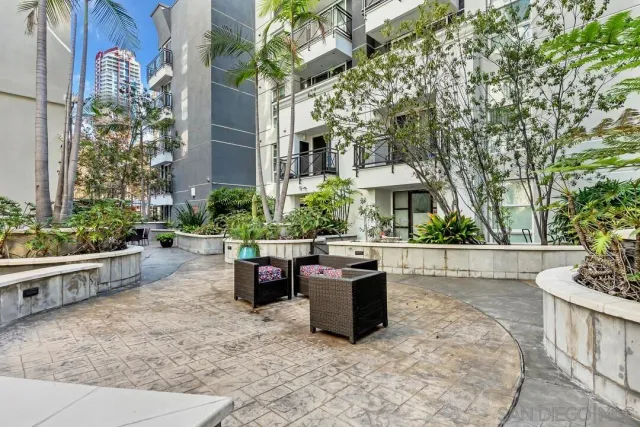 a view of a patio with table and chairs and potted plants