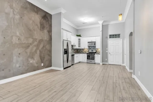 a view of a kitchen with wooden floor and a refrigerator