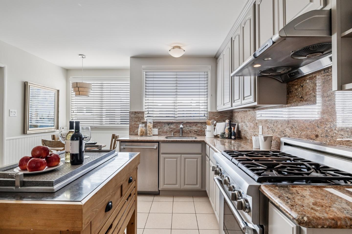 86 Cliffside Drive Daly City, CA 94015 - Photo 12 of 50 a kitchen with stainless steel appliances a sink a stove and a window